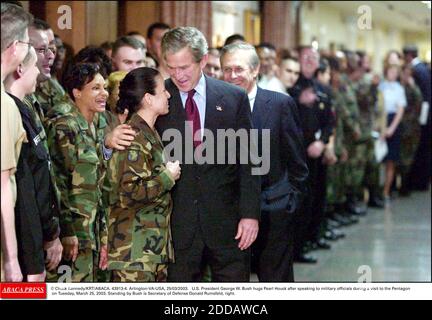 NO FILM, NO VIDEO, NO TV, NO DOCUMENTARY - © Chuck Kennedy/KRT/ABACA. 43913-4. Arlington-VA-USA, 25/03/2003. U.S. President George W. Bush hugs Pearl Houck after speaking to military officials during a visit to the Pentagon on Tuesday, March 25, 2003. Standing by Bush is Secretary of Defense Donal Stock Photo