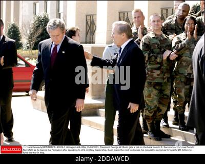 NO FILM, NO VIDEO, NO TV, NO DOCUMENTARY - © Chuck Kennedy/KRT/ABACA. 43929-1. Arlington-VA-USA, 25/03/2003. President George W. Bush gets a pat on the back from U.S. Secretary of Defense Donald Rumsfeld as he leaves the Pentagon after speaking to U.S. military leadership. Bush made the visit to d Stock Photo