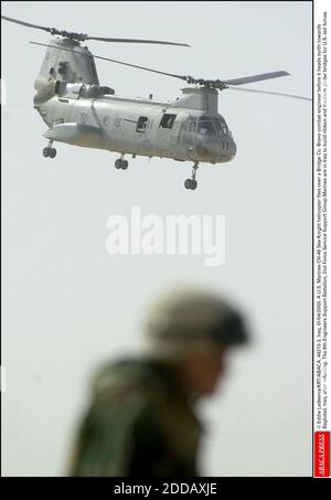 NO FILM, NO VIDEO, NO TV, NO DOCUMENTARY - © Eddie Ledesma/KRT/ABACA. 44213-3. Iraq, 01/04/2003. A U.S. Marines CH-46 Sea Knight helicopter flies over a Bridge Co. Bravo combat engineer before it heads north towards Baghdad, Iraq, after refueling. The 8th Engineers Support Battalion, 2nd Force Ser Stock Photo