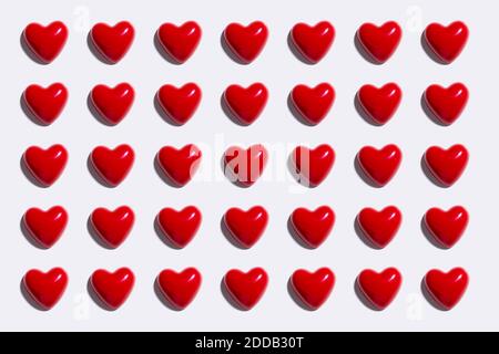 Pattern of red hearts against white background Stock Photo