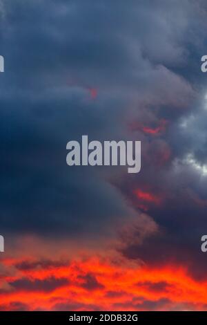 Dark clouds illuminated by setting sun Stock Photo