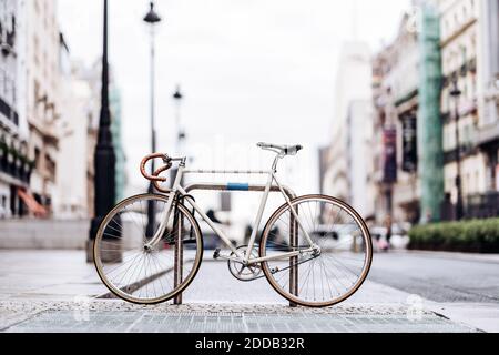 Racing bicycle locked to bicycle rack Stock Photo