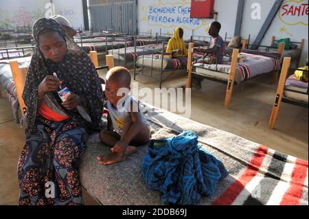 Migrants stop by a transit centre in Laghouate, Algeria, June 28, 2018 on their way from Algiers to Tamanrasset, 2,000 km south of Algiers. Nigerian illegal migrants (majority of women and children) who lived in Algeria by begging, according to the Algerian authorities, will be returned to their country once the administrative arrangements are completed. Photo by Louiza Ammi/ABACAPRESS.COM Stock Photo