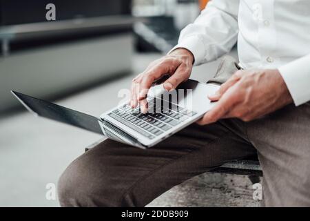 Male engineer using laptop in factory Stock Photo