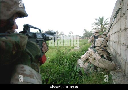 NO FILM, NO VIDEO, NO TV, NO DOCUMENTARY - A Marine from Echo Company, 2nd Battalion 4th Marines looks for cover during a firefight in Ramadi, Iraq, on April 10, 2004. Photo by David Swanson/Philadelphia Inquirer/KRT/ABACA. Stock Photo