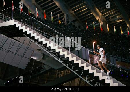 NO FILM, NO VIDEO, NO TV, NO DOCUMENTARY - Greek Olympian Nikos Kaklamanaki carries the flame up steps to light the ceremonial torch during the opening ceremonies for the 2004 Olympic Games on Friday, August 13, 2004, in Athens, Greece. Photo by Nhat V. Meyer/San Jose Mercury News/KRT/ABACA. Stock Photo