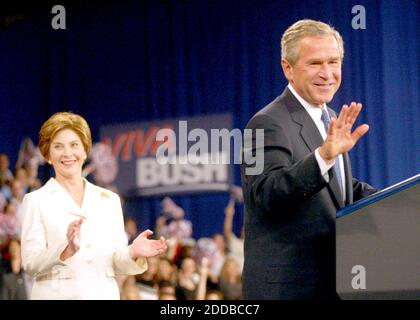 NO FILM, NO VIDEO, NO TV, NO DOCUMENTARY - As First Lady Laura Bush applauds, President George W. Bush greets a supportive crowd at the Coconut Grove Convention Center, in Coconut Grove, Florida, following the first presidential debate at the University of Miami, Thursday, September 30, 2004. Photo by Patrick Farrell Miami Herald/KRT/ABACA. Stock Photo