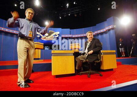 NO FILM, NO VIDEO, NO TV, NO DOCUMENTARY - Lester M. Crystal, left, executive producer of PBS' The NewsHour with Jim Lehrer, tries to get a louder round of applause from the sparse crowd watching Jim Lehrer, right, practice his introduction at the University of Miami's Convocation Center in Coral Gables, Florida, on Wednesday, September 29, 2004. Lehrer is moderating the first presidential debate. Photo by Jared Lazarus/KRT/Miami Herald/ABACA Stock Photo