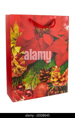 Horizontal color image with a front view of a red Christmas shopping bag made of paper decorated with green and red leaves, pine cones and Christmas b Stock Photo