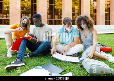Male and female students studying together in campus at university Stock Photo