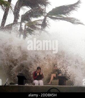 NO FILM, NO VIDEO, NO TV, NO DOCUMENTARY - Unidentified storm spectators are hit by a wave near the Southernmost Point in Key West, Florida, on Tuesday, September 20, 2005. (Photo by Chuck Fadely/Miami Herald/KRT/ABACAPRESS.COM Stock Photo