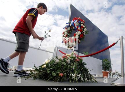 NO FILM, NO VIDEO, NO TV, NO DOCUMENTARY - Joel Scheving, 11, of Moorehead, Minnesota, places a flower near the Space Memorial Mirror at Kennedy Space Center Visitors Complex, Florida, Saturday, January 28, 2006. Astronauts Memorial Foundation conducted a ceremony to honor the crew of Challenger STS 51L and all astronauts who have sacrificed their lives on the 20th anniversary of the Challenger accident. Photo by Red Huber/Orlando Sentinel/KRT/ABACAPRESS.COM