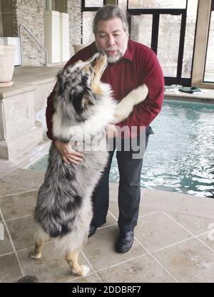 NO FILM, NO VIDEO, NO TV, NO DOCUMENTARY - Apple Computer co-founder Steve Wozniak gets a kiss from his dog, Cruiser, an Australian Shepard in the lower level of his house next to the indoor pool in Los Gatos, California, Wednesday, March 15, 2006. Photo by Karen T. Borchers/San Jose Mercury News/KRT/ABACAPRESS.COM Stock Photo