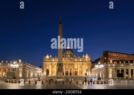 Illuminated St. Peter's Square with obelisk and St. Peter's Basilica against clear blue sky at night, Vatican City, Rome, Italy Stock Photo