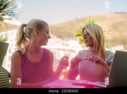 Young women with laptop having a meeting Stock Photo