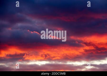Dark clouds illuminated by setting sun Stock Photo