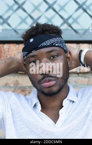 Confident young man wearing headscarf Stock Photo