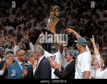 Heat forward LeBron James holds the NBA championship trophy after