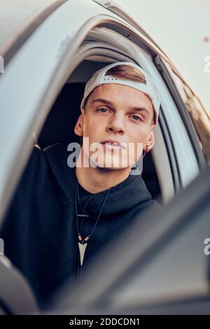 Confident young man sitting in car Stock Photo