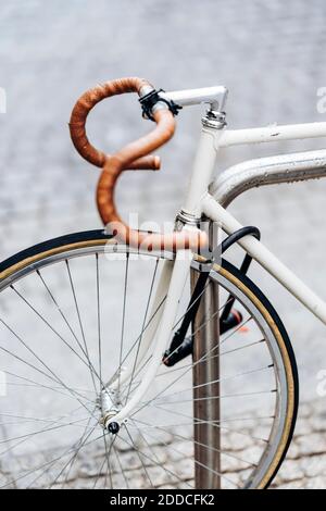 Racing bicycle locked to bicycle rack Stock Photo