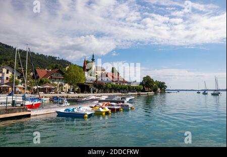 Austria, Upper Austria, Attersee am Attersee, Pedal boats moored in marina of lakeshore village in summer Stock Photo
