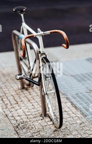 Racing bicycle locked to bicycle rack Stock Photo
