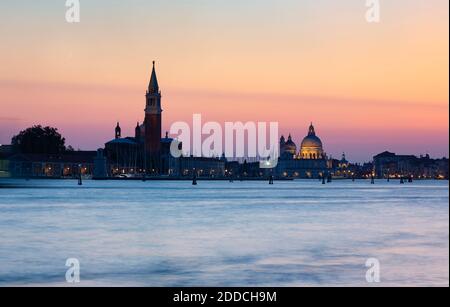 Italy, Veneto, Venice, Venetian waterfront at dusk with Santa Maria della Salute and San Giorgio Maggiore churches in background Stock Photo