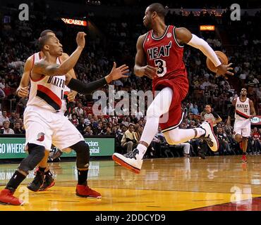 NO FILM, NO VIDEO, NO TV, NO DOCUMENTARY - Miami Heat guard Dwyane Wade passes the ball back to teammate LeBron James, as he drives against the Portland Trail Blazers' Damian Lillard (0) in the first quarter at the AmericanAirlines Arena in Miami, Florida, Tuesday, February 12, 2013. The Heat beat the Blazer, 117-104. Photo by Pedro Portal/El Nuevo Herald/MCT/ABACAPRESS.COM Stock Photo