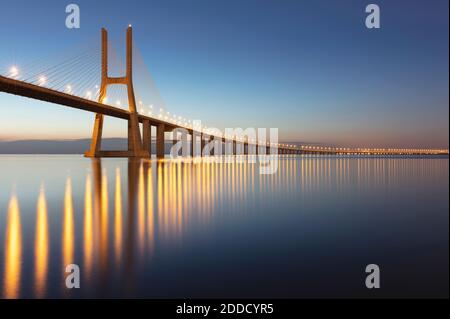 Portugal, Lisbon District, Lisbon, Vasco da Gama Bridge at dusk Stock Photo
