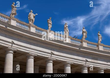 Saint statues on St. Peter's Basilica against blue sky on sunny day, Vatican City, Rome, Italy Stock Photo