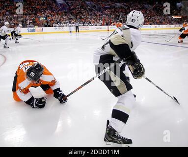 NO FILM, NO VIDEO, NO TV, NO DOCUMENTARY - The Philadelphia Flyers' Claude Giroux sits on the ice as the Pittsburgh Penguins' Sidney Crosby holds his stick during the second period at the Wells Fargo Center in Philadelphia, PA, USA on March 7, 2013. Pittsburgh won, 5-4. Photo by Yong Kim/Philadelphia Daily News/MCT/ABACAPRESS.COM Stock Photo
