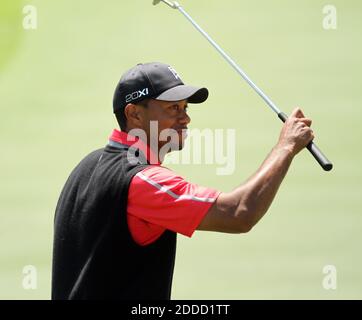 Tiger Woods waves to the gallery after his putt on the 18th green ...