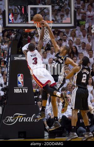 NO FILM, NO VIDEO, NO TV, NO DOCUMENTARY - The Miami Heat's Dwyane Wade (3) dunks over the San Antonio Spurs' Tim Duncan (21) in Game 6 of the NBA Finals at the AmericanAirlines Arena in Miami, FL, USA June 18, 2013. Photo by Allen Eyestone/Palm Beach Post/MCT/ABACAPRESS.COM Stock Photo
