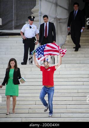 NO FILM, NO VIDEO, NO TV, NO DOCUMENTARY - Julio Diaz, 28, right, of Chicago, Illinois, runs down the steps of the Supreme Court in celebration after the Court ruled 5-4 to strike down the Defense of Marriage Act, Wednesday, June 26, 2013, in Washington, DC, USA. Photo by Pete Marovich/MCT/ABACAPRESS.COM Stock Photo