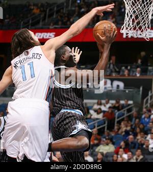 NO FILM, NO VIDEO, NO TV, NO DOCUMENTARY - Orlando Magic guard Victor Oladipo scores under Charlotte Bobcats forward Josh McRoberts (11) during game action at the Amway Center in Orlando, FL, USA on January 17, 2014. Photo by Stephen M. Dowell/Orlando Sentinel/MCT/ABACAPRESS.COM Stock Photo