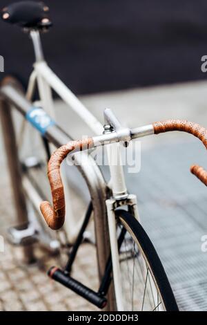 Handlebar of racing bicycle locked to bicycle rack Stock Photo