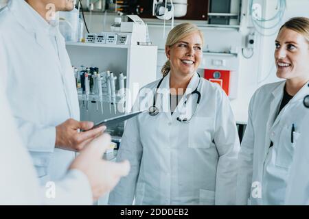 Smiling male and female scientist standing at laboratory Stock Photo