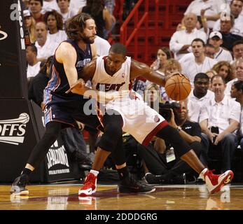 NO FILM, NO VIDEO, NO TV, NO DOCUMENTARY - Miami Heat forward Chris Bosh, right goes to the basket against Charlotte Bobcats defender Josh McRoberts in the second quarter of Game 1 of the NBA Eastern Conference quarterfinals at the American Airlines Arena in Miami, FL, USA on April 20, 2014. The Heat beat the Bobcats, 99-88. Photo by Hector Gabino/El Nuevo Herald/MCT/ABACAPRESS.COM Stock Photo