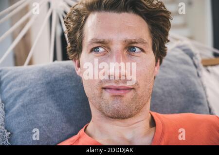 Close-up of man lying in hammock at home Stock Photo