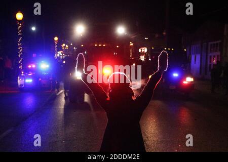 NO FILM, NO VIDEO, NO TV, NO DOCUMENTARY - A protester raises her hands in the street as police use tear gas to try to take control of the scene near a Ferguson Police Department squad car after protesters lit it on fire on Tuesday, November 25, 2014, in the wake of the grand jury decision not to indict officer Darren Wilson in the shooting death of Ferguson, Mo., teen Michael Brown. Photo by Anthony Souffle/Chicago Tribune/TNS/ABACAPRESS.COM Stock Photo