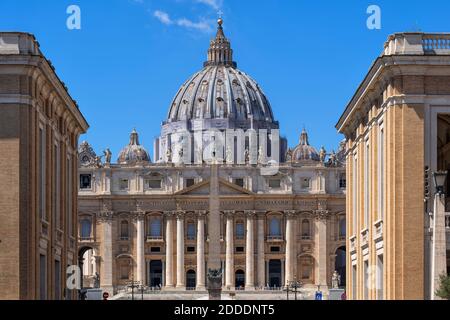St. Peter's Basilica in city against blue sky on sunny day Stock Photo