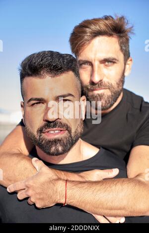 Handsome gay couple spending leisure time together during sunny day Stock Photo