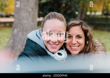 Smiling beautiful mid adult women enjoying autumn at park Stock Photo