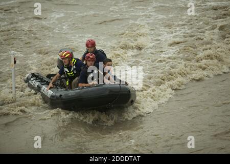 NO FILM, NO VIDEO, NO TV, NO DOCUMENTARY - Rescue personnel from the Austin Fire Department bring a man to safety after he became trapped by rushing water at House Park on Monday, May 25, 2015, in Austin, Texas. Shoal Creek overflowed its banks and transformed Lamar Boulevard into a rushing torrent of muddy water. Several cars were stranded along the normally busy street. Photo by Alberto Martinez/Austin-American Statesman/TNS/ABACAPRESS.COM Stock Photo