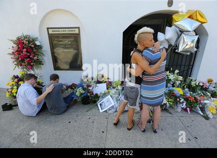 NO FILM, NO VIDEO, NO TV, NO DOCUMENTARY - Alston Rich, from left, Brad Hutchinson, Ashley Edge and Elizabeth Elliott comfort each other at the memorial in front of the Emanuel AME Church where 9 people were killed including the pastor on Thursday, June 18, 2015, in Charleston, SC, USA. Photo by Curtis Compton/Atlanta Journal-Constitution/TNS/ABACAPRESS.COM Stock Photo