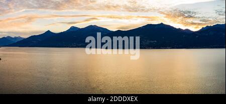 Helicopter view of Lake Como at dawn with silhouettes of mountains in background Stock Photo