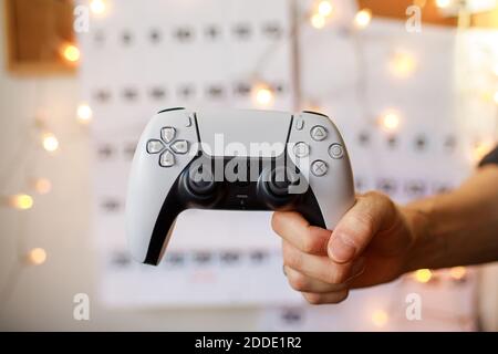 PlayStation 5 Sony reveals PS5 console and games. Dualsense controller. Woman holding joystick Stock Photo