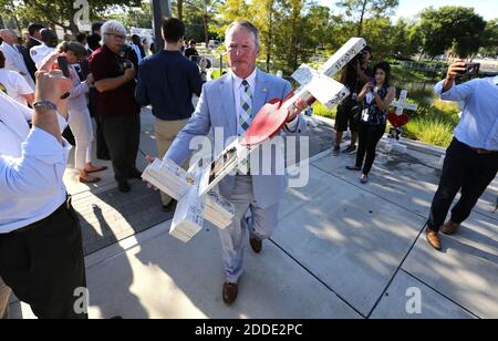 NO FILM, NO VIDEO, NO TV, NO DOCUMENTARY - On the one-month anniversary of the Pulse nightclub massacre in Orlando, FL, USA., mayor Buddy Dyer carries one of the crosses that was erected to honor victims at Orlando Regional Medical Center, to transfer the crosses to the Orange County Regional History Center, Tuesday, July 12, 2016. Photo by Joe Burbank/Orlando Sentinel/TNS/ABACAPRESS.COM Stock Photo