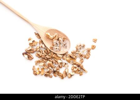 Peeled dried pieses of walnuts on wooden spoon isolated on white background Stock Photo