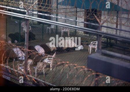 NO FILM, NO VIDEO, NO TV, NO DOCUMENTARY - War-on-terror captives from two different cellblocks, separated by a fence, conduct communal evening prayers at the Camp 6 prison building for cooperative captives at the U.S. Navy Base at Guantanamo Bay, Cuba, on Tuesday, July 7, 2015. This photo was taken through a closed window. U.S. Army soldiers reviewed this photo invoking Pentagon security restrictions and cleared it for release. Photo by Walter Michot/Miami Herald/TNS/ABACAPRESS.COM Stock Photo